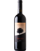 Le Macchiole Paleo Bianco Toscana 2024 IGT bottle with elegant label and white wine in a glass on a wooden table.